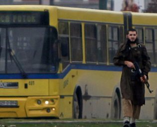 A gunman with an automatic weapon walks in Sarajevo, after he fired shots at the U.S. embassy, October 28, 2011. The gunman with an automatic weapon opened fire at the United States embassy in the Bosnian capital Sarajevo on Friday and police rushed to the scene, a Reuters witness said. A Reuters photographer said police were trying to surround the gunman, who was armed with a Kalashnikov rifle. REUTERS/Dado Ruvic (BOSNIA AND HERZEGOVINA - Tags: CRIME LAW TPX IMAGES OF THE DAY)