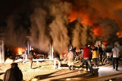 epa09456369 Smoke rises as firemen and civilians try to extinguish a fire that broke out at a hospital for Covid-19 patients in Tetovo, Republic of North Macedonia, 08 September 2021. Multiple casualties have been reported by Ministry of Health when a fire, thought to have been triggered by oxygen cylinders that provide oxygen to patients with a more severe clinical case of Covid-19, broke at the hospital.  EPA-EFE/STRINGER