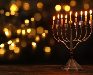 image of jewish holiday Hanukkah background with menorah (traditional candelabra) and burning candles